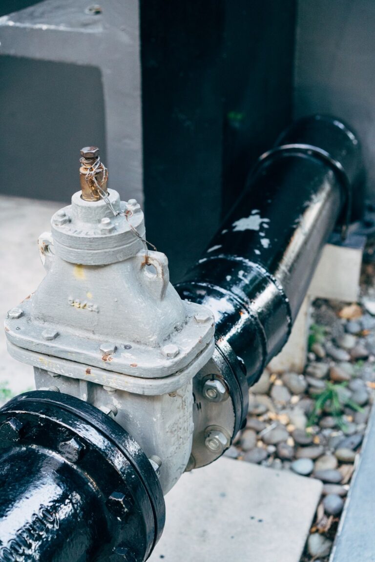 Close-up of plumbing pipes affected by hard water mineral buildup in Morton IL
