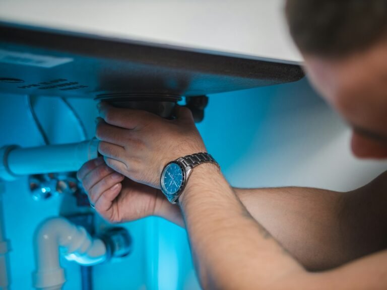 Plumber servicing a water heater scaled by hard water in Peoria Heights, IL